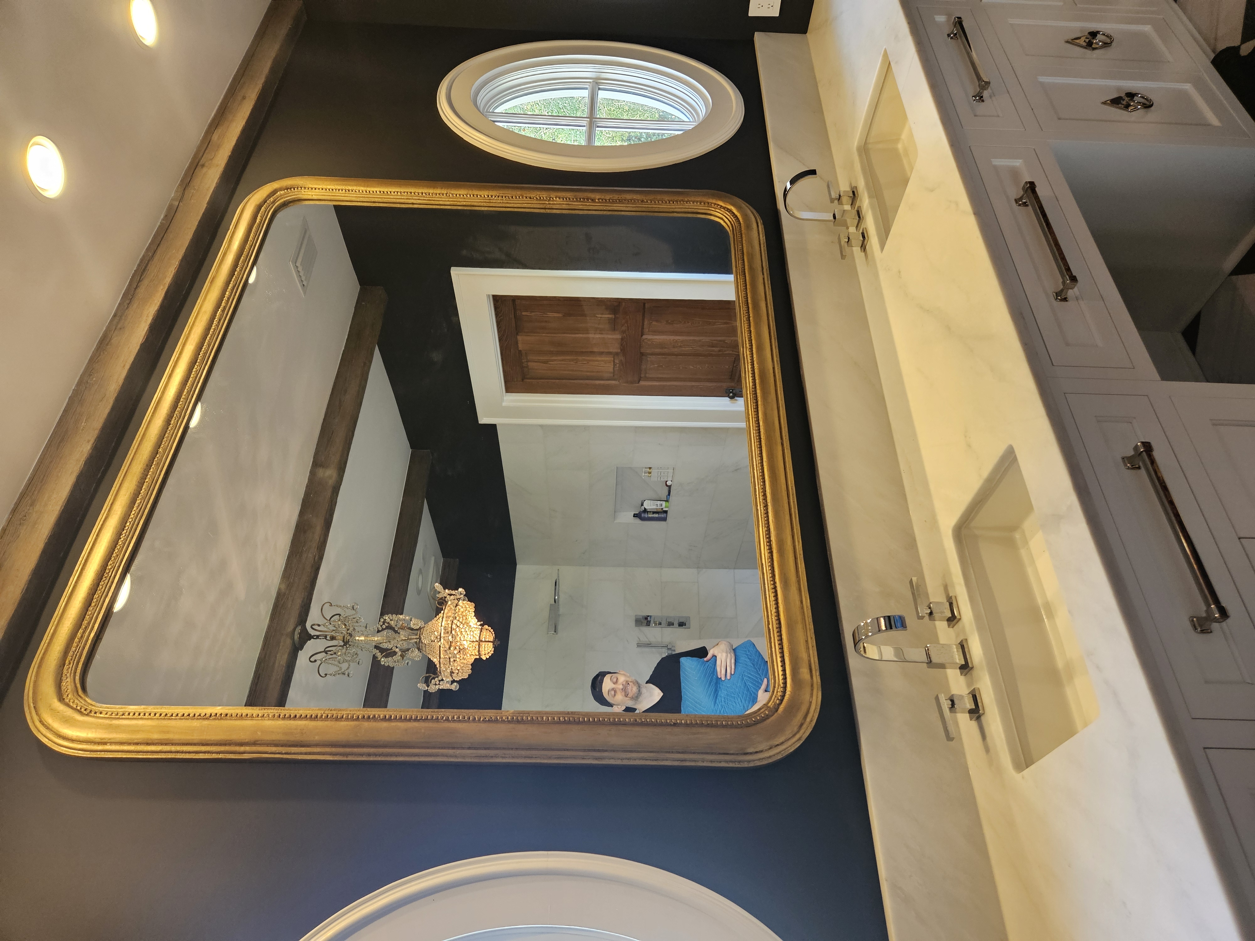 Custom framed bathroom mirror with decorative moulding displayed in an upscale residential bathroom by Friedman’s Framing in Savannah, GA
