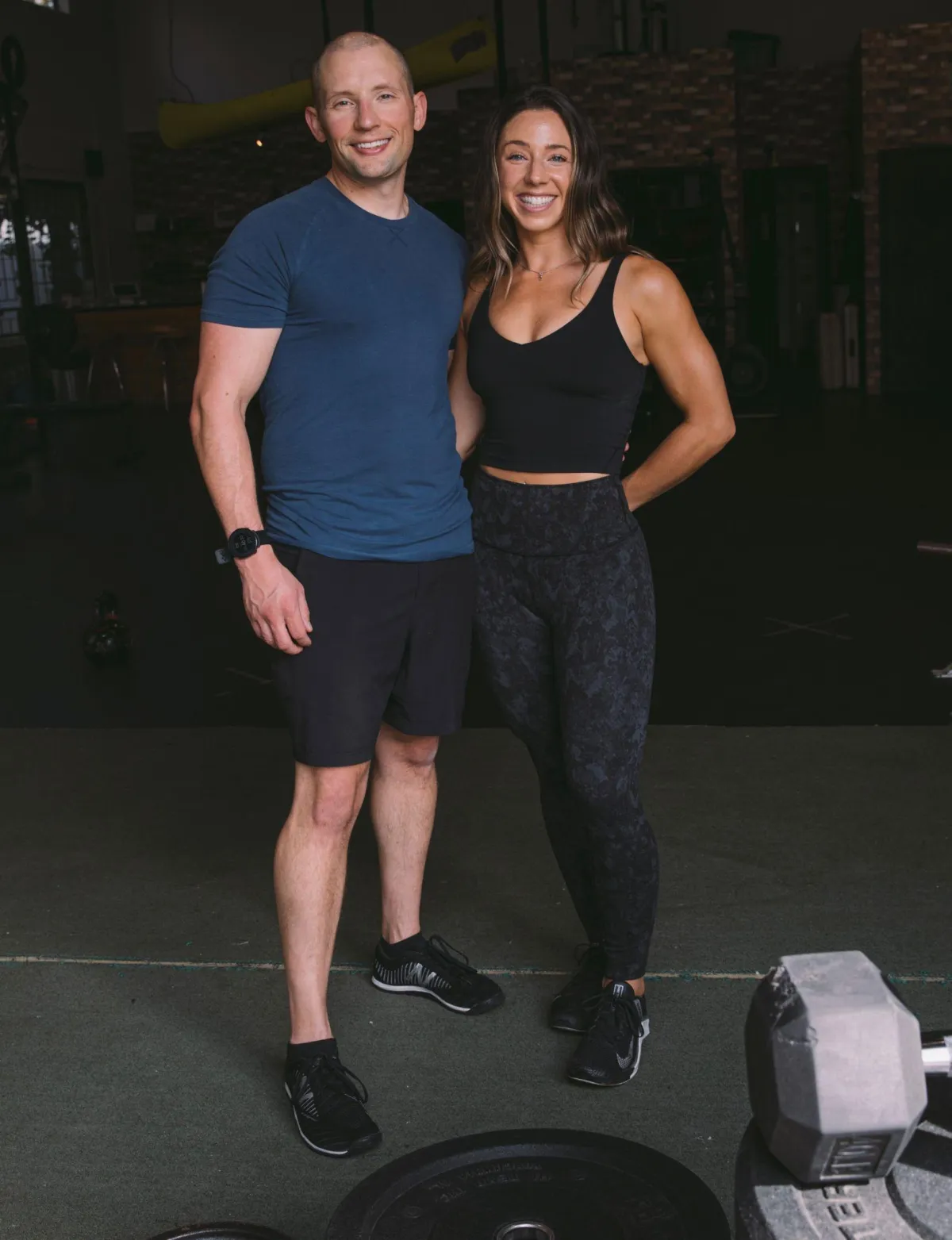 Two people doing yoga in a park.