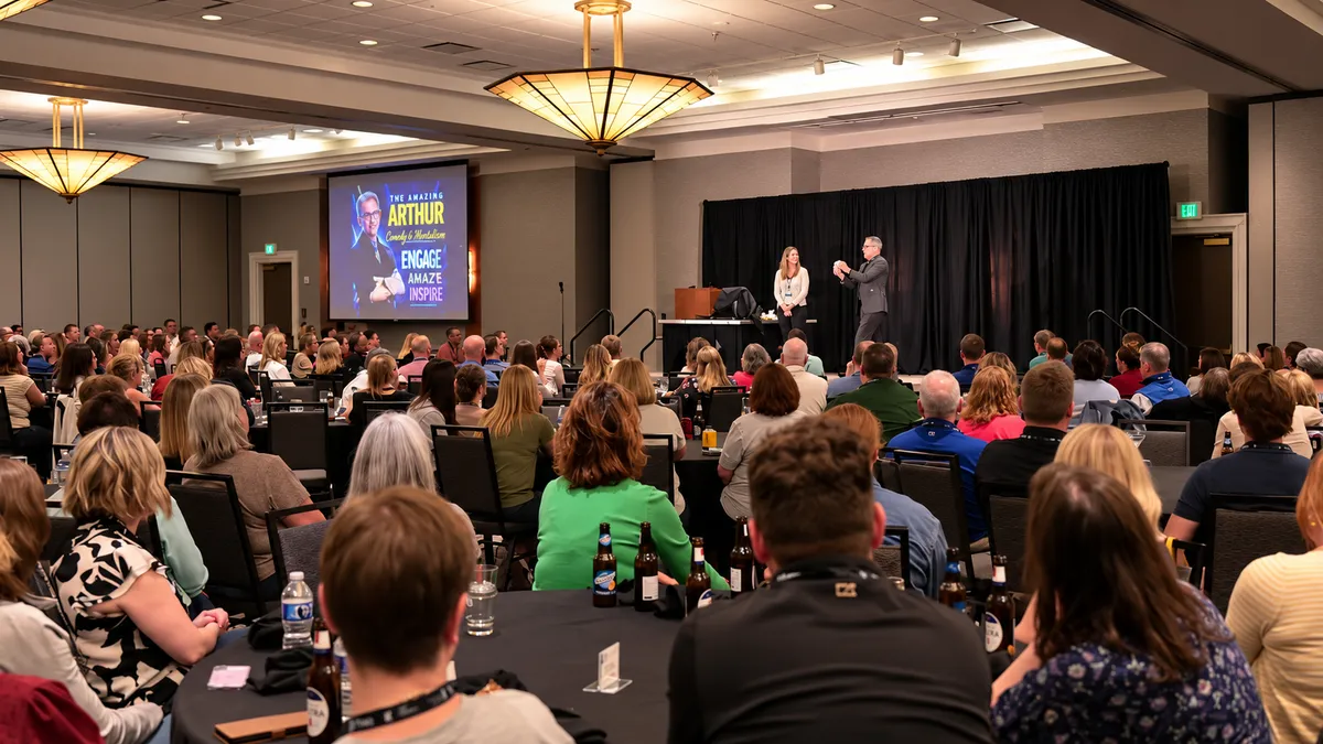 Arthur leading an interactive, joy-filled corporate hypnosis demonstration on a grand stage