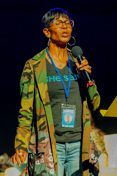 Women singing holding a microphone