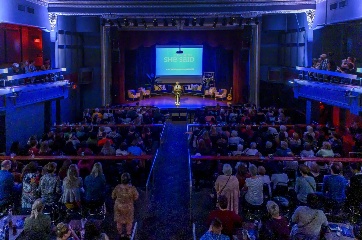 A full theater with a TWSS performance on stage