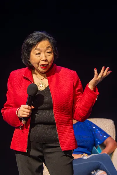 Women talking holding a microphone