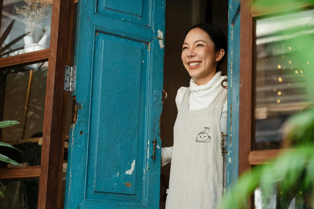 Smiling business woman in a bright workspace, symbolising AP360 Marketing’s collaborative and creative approach.