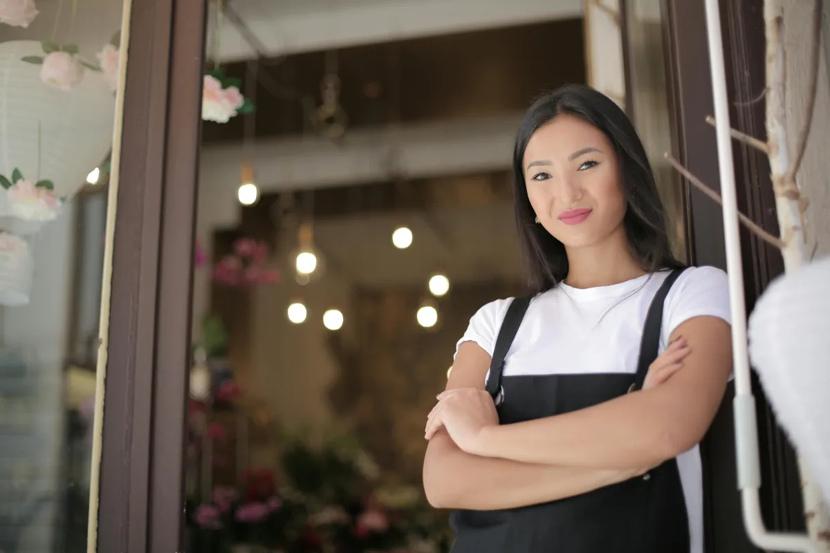 Confident business owner standing with arms folded, illustrating trust, professionalism and growth potential.