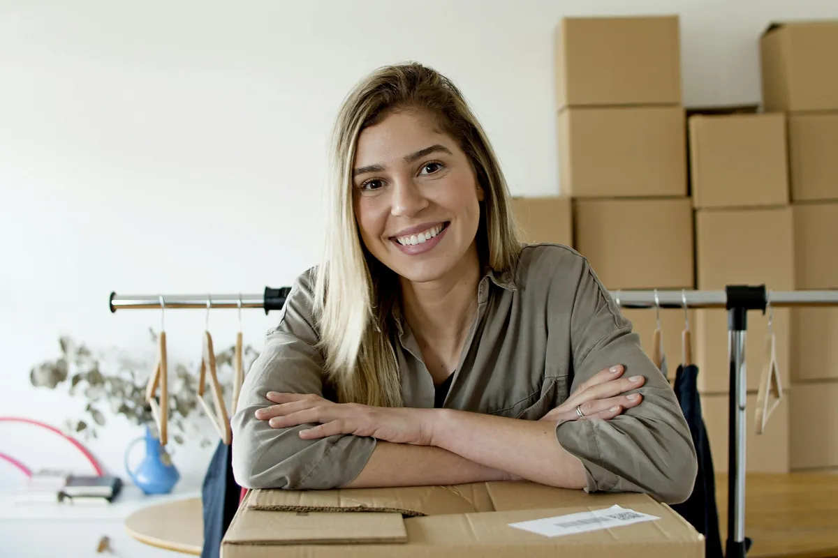 Confident marketing consultant smiling at her desk, representing AP360 Marketing’s expertise in guiding small businesses and start-ups.