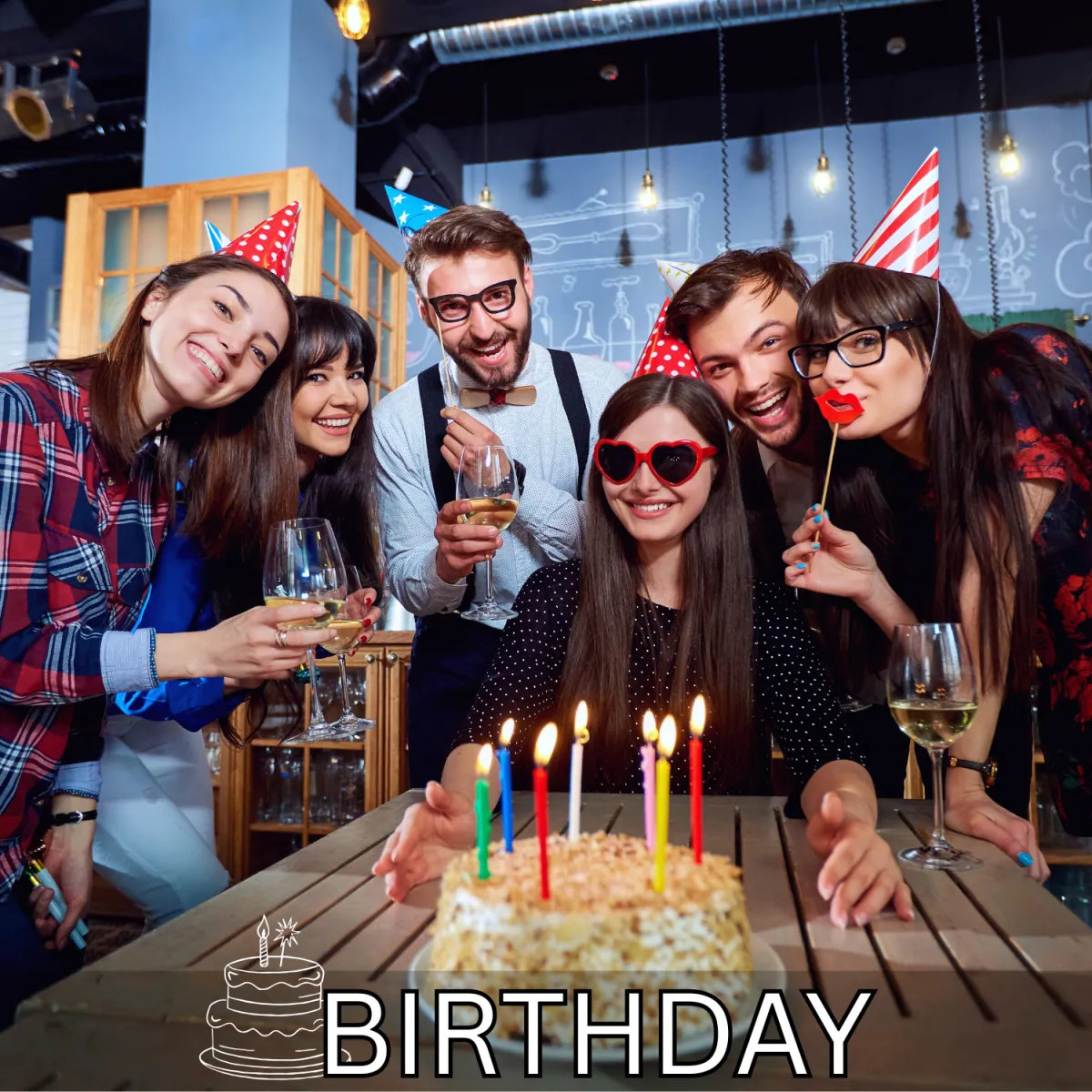 Friends celebrating a birthday together with a cake and candles