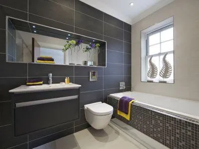 Luxury bathroom renovation in NYC, showcasing new tiles, a sleek vanity, and a glass shower.