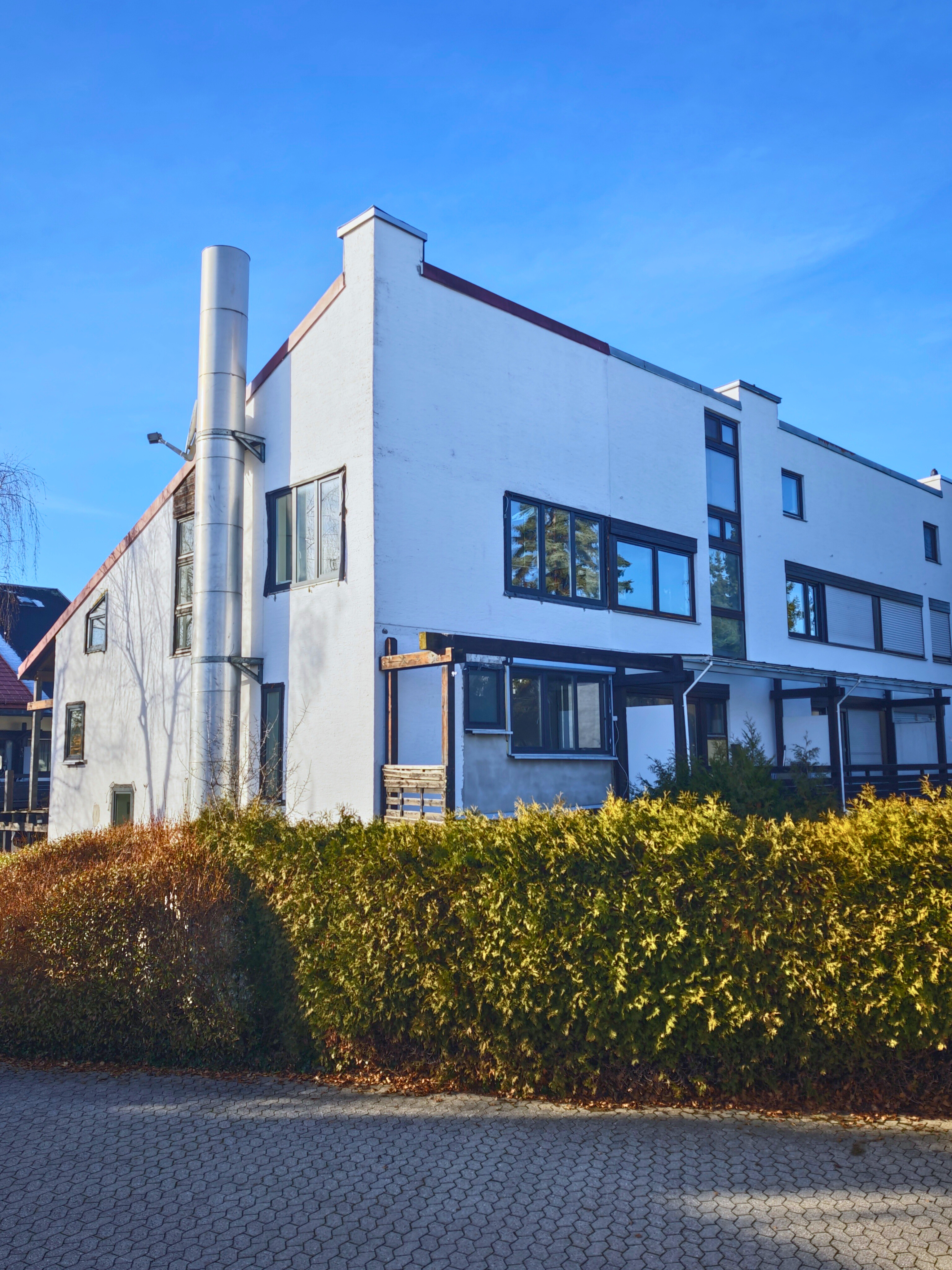 man sitting by the desk using laptop computer