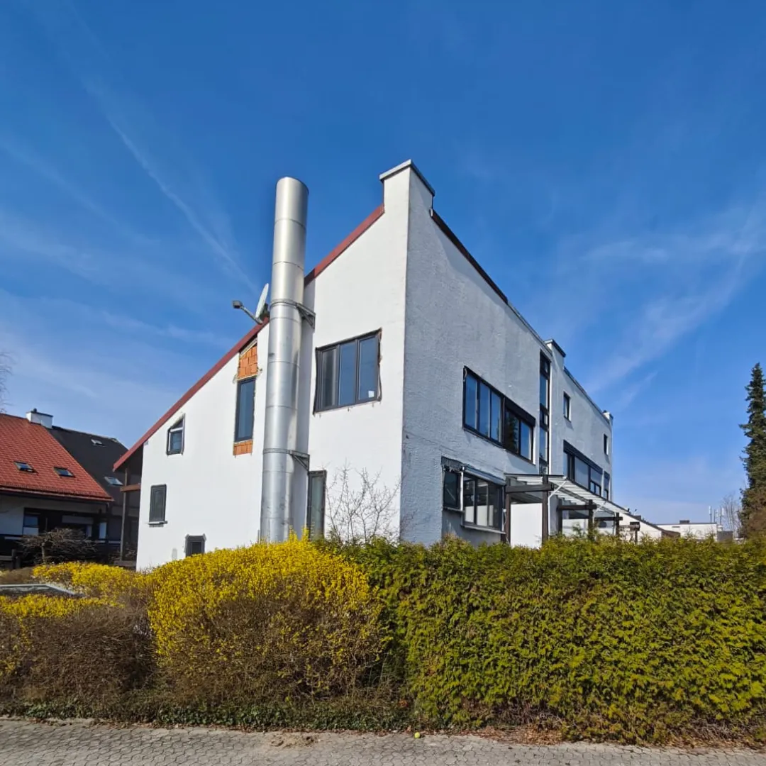 man sitting by the desk using laptop computer