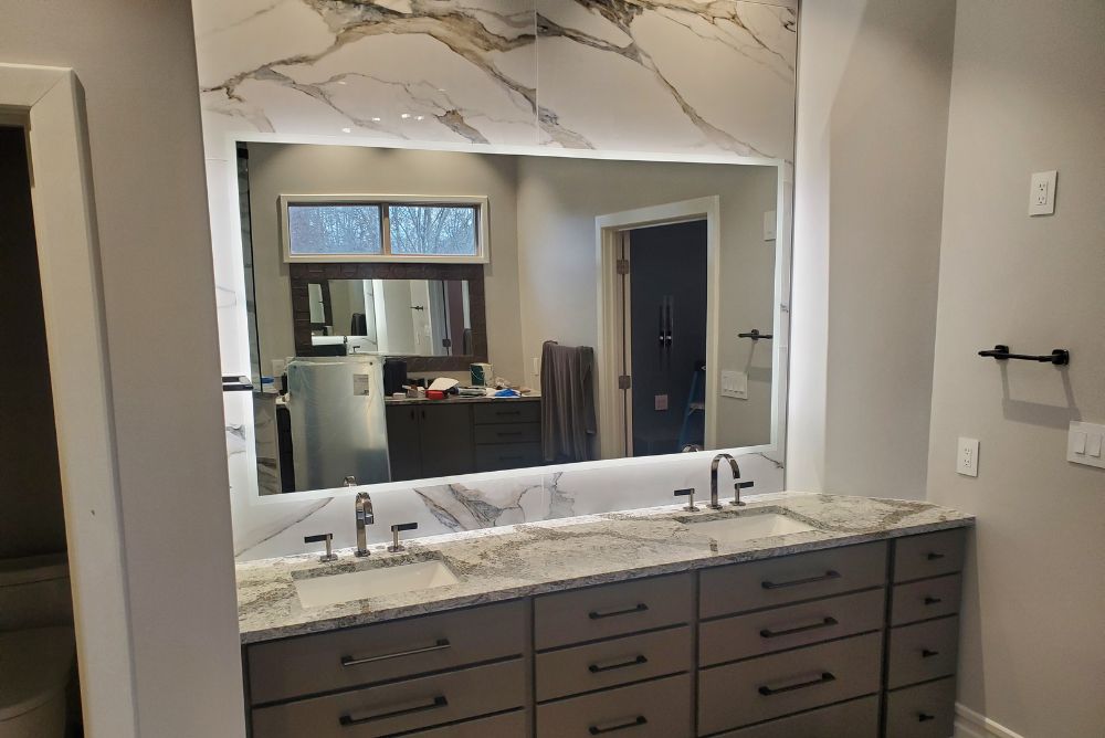 Custom backlit bathroom vanity mirror installed by RDB Glass in Dayton, Ohio, featuring a frameless design and LED illumination for a modern bathroom upgrade.