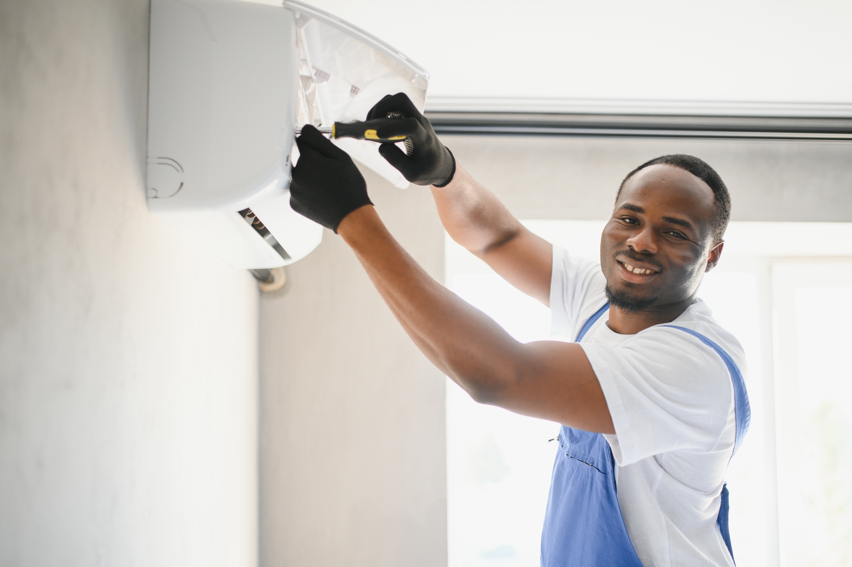 a technician installing air conditioner 