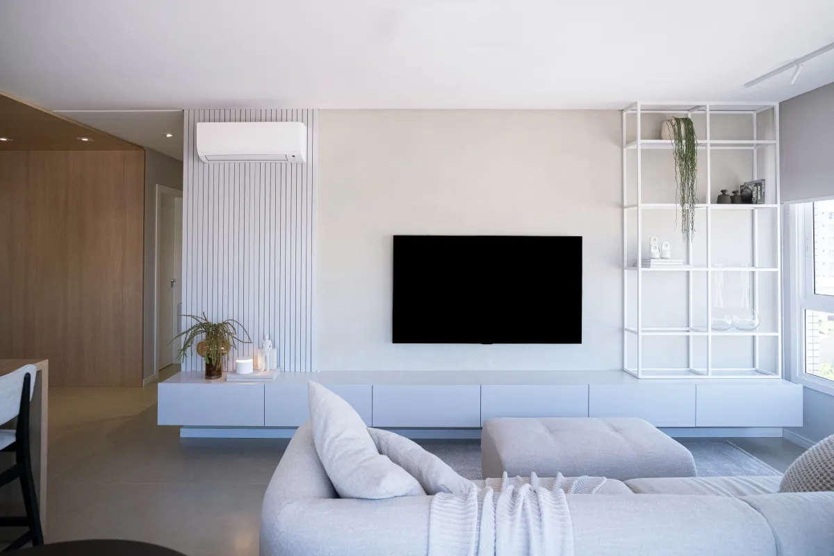 Modern living room with a stylish air conditioning unit, emphasizing the importance of reliable AC services to ensure comfort and efficiency for homeowners.