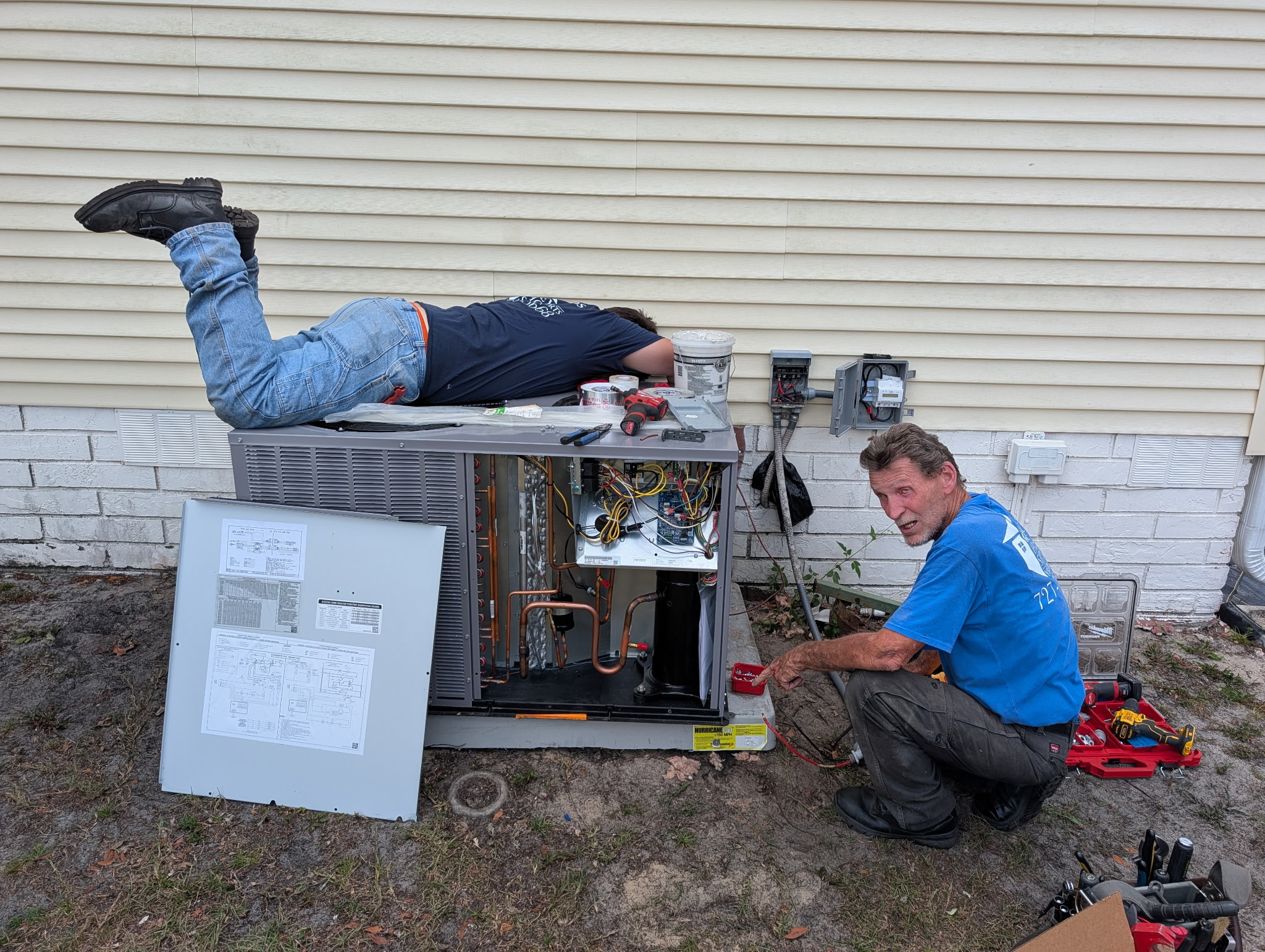 Technician repairing an air conditioning unit in a modern home, emphasizing same-day AC repair service