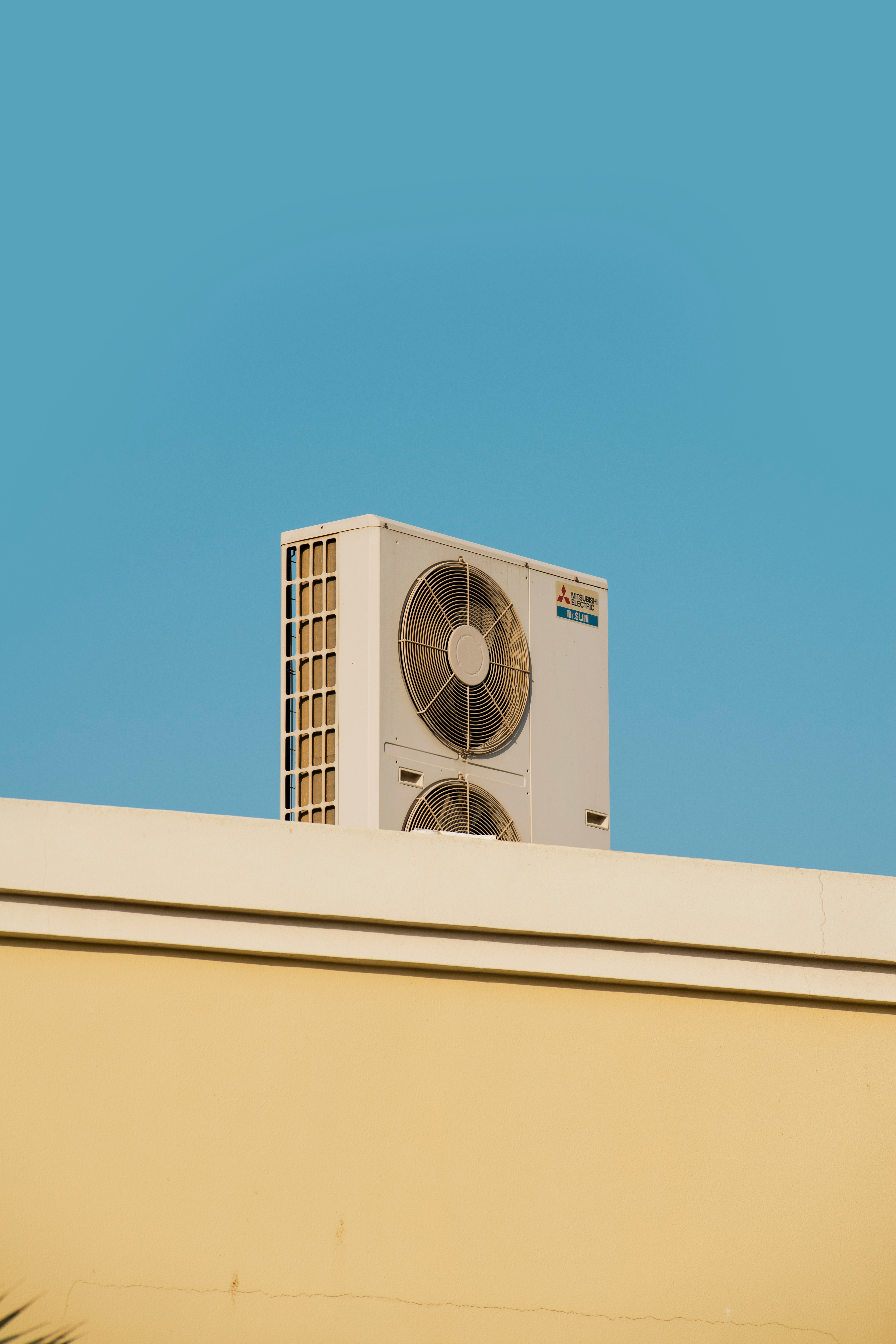 AC unit installed outdoors next to a building 