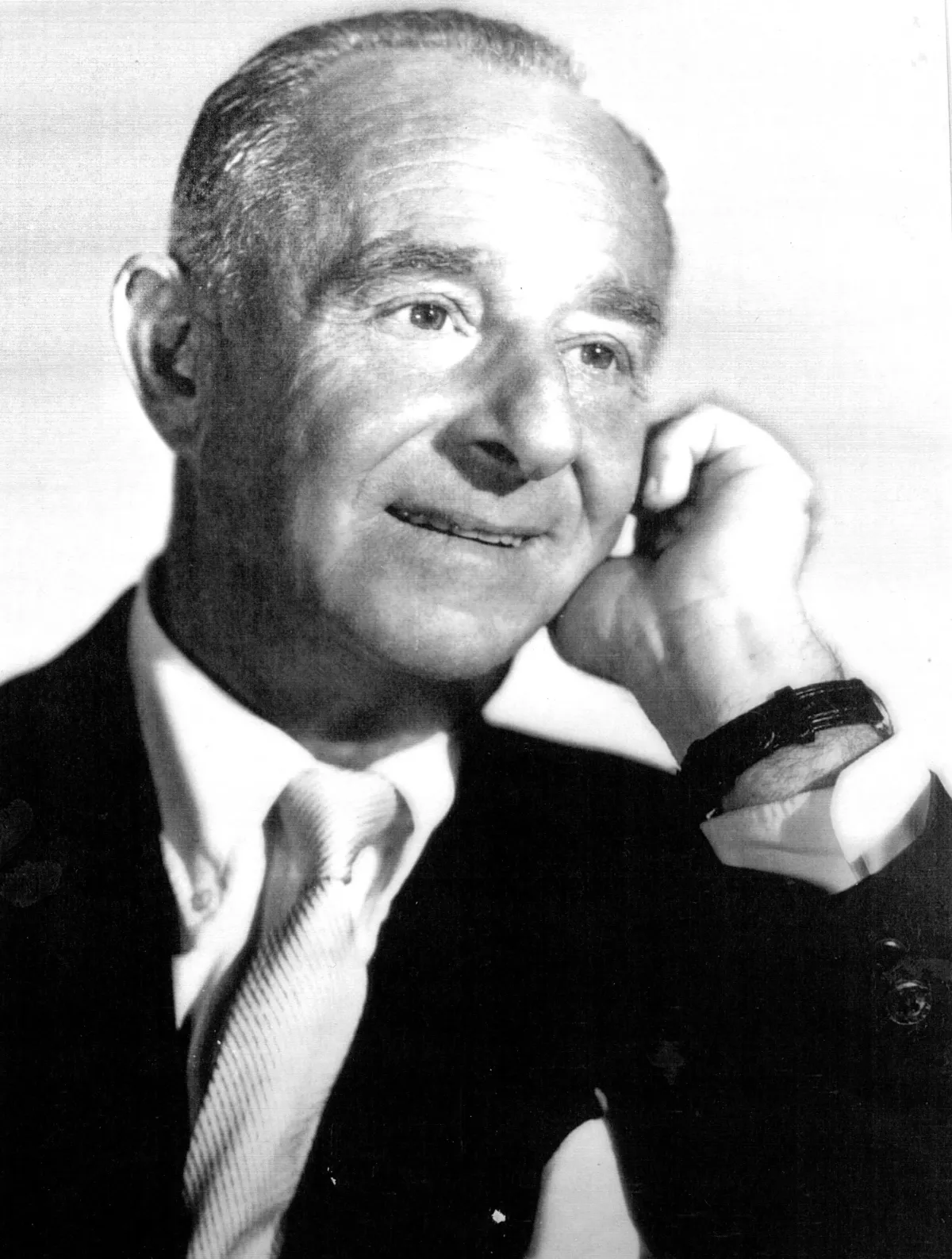 Portrait of Edward Small learning supporting his head with wrist smilling