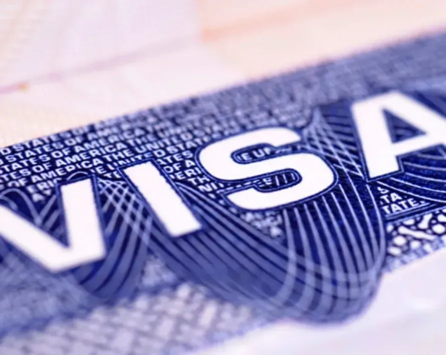 baby in white onesie lying on green textile