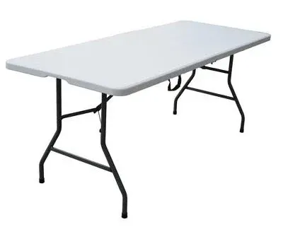 A rectangular farmhouse-style wooden table with a rustic finish, set up for a buffet in a lush garden setting.