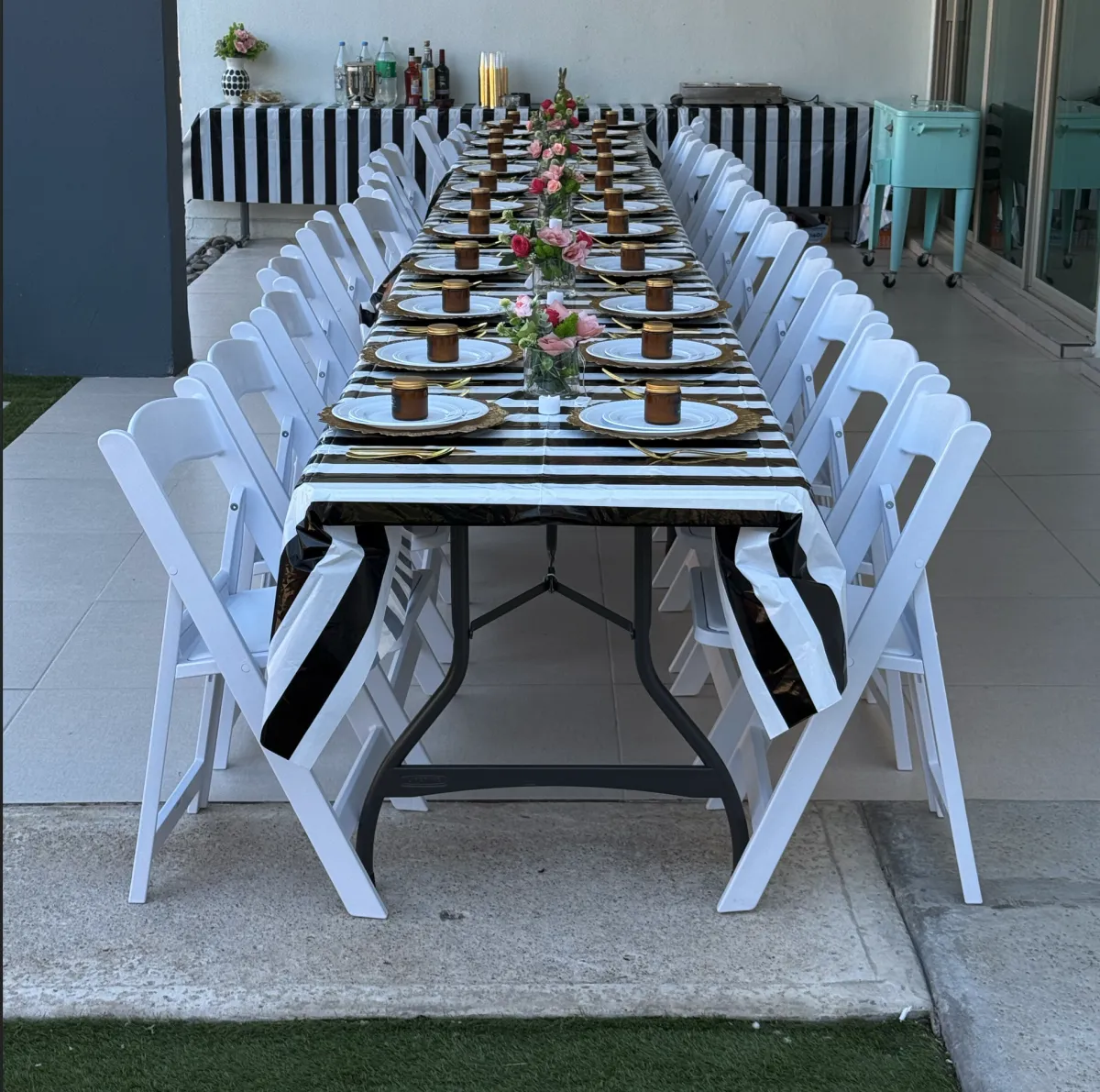 A modern indoor event setup with clear ghost chairs and square tables, styled with minimalist decor and soft ambient lighting. The arrangement highlights clean lines and a contemporary aesthetic, perfect for chic gatherings.