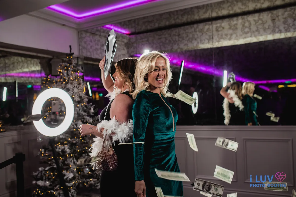 2 women on 360 photo booth at a holiday party Jersey City NJ