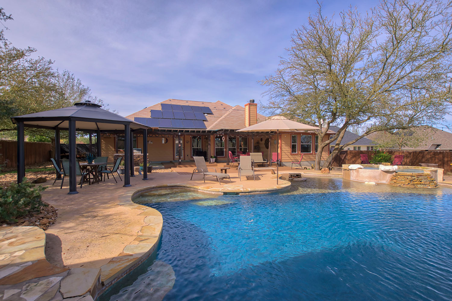 Residential real estate photography of a home with swimming pool and outdoor living area