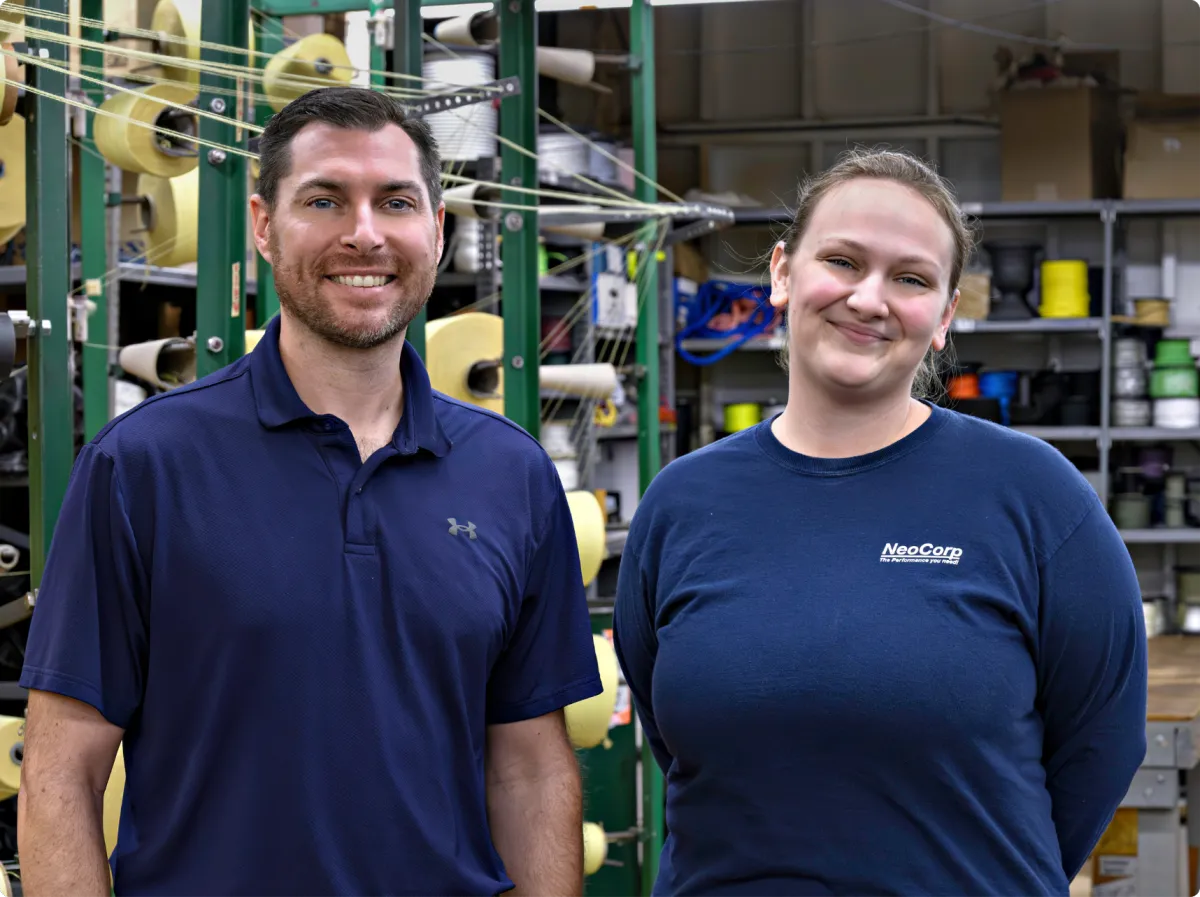 Two employees in a manufacturing facility