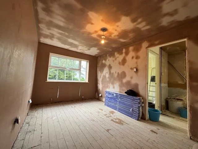 Plastered living room wall with soft neutral tones
