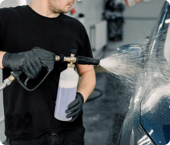Car detailing process - Spraying cleaner on the vehicle
