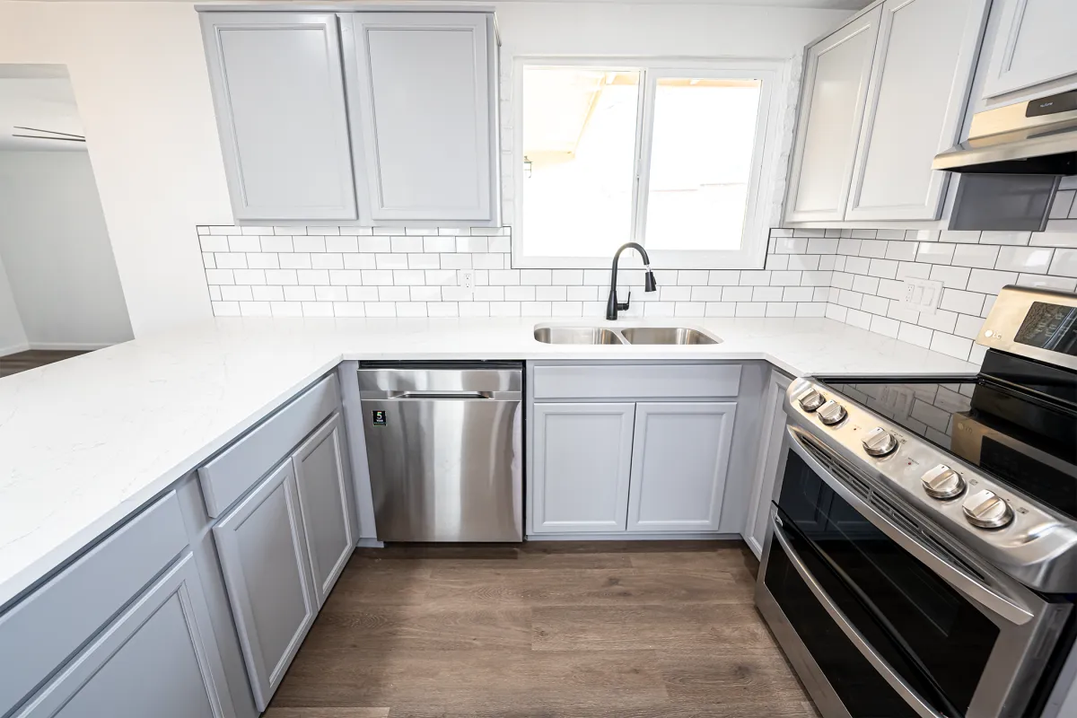 a kitchen with a new cabinets and lighting