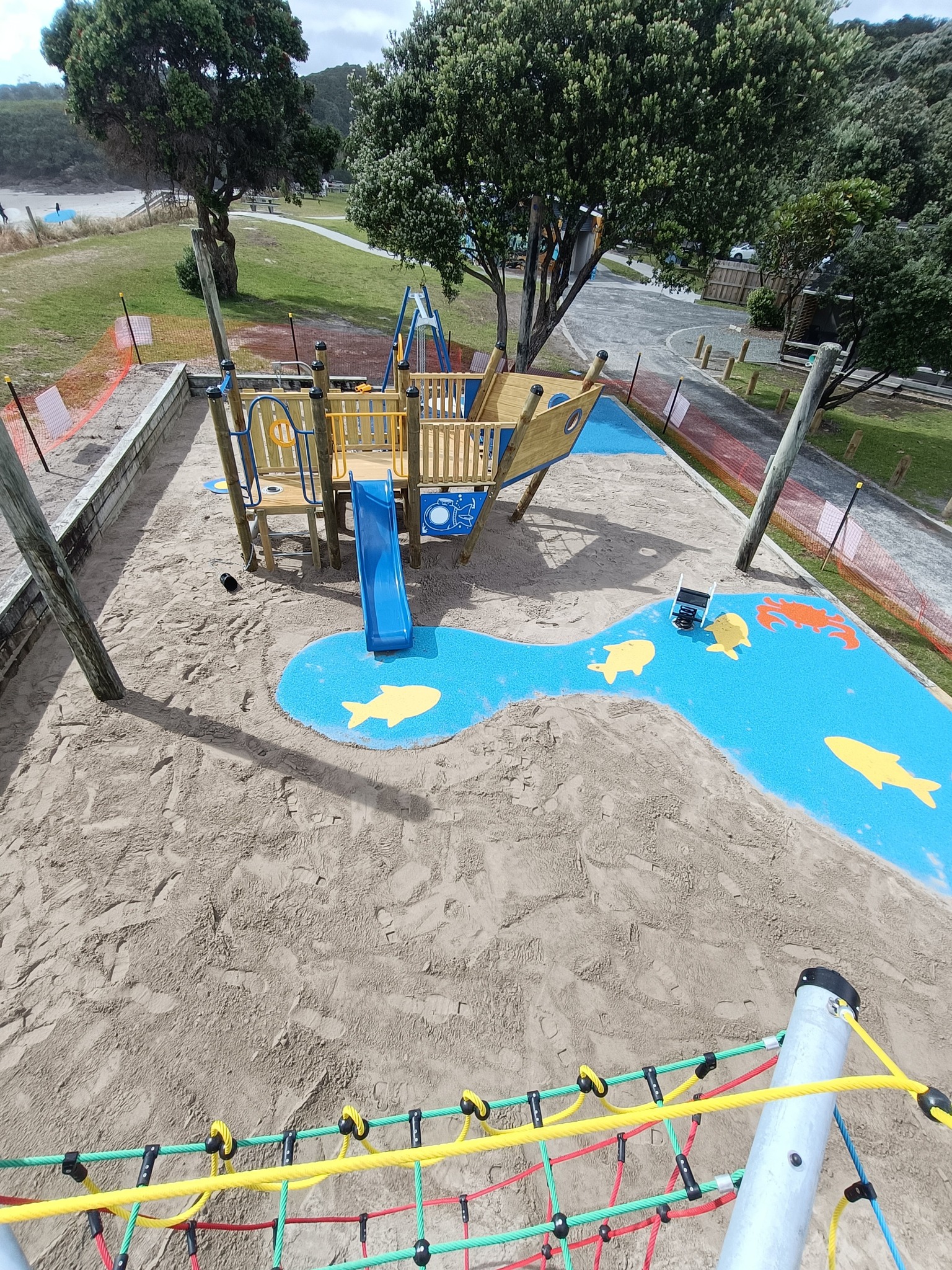 Timber playground with slide and mulch surfacing designed by Aspect Contracting