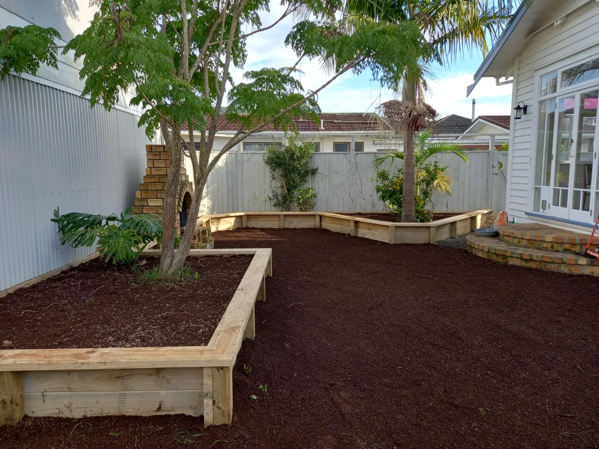 Northland landscape design with timber planters and mulch by Aspect Contracting