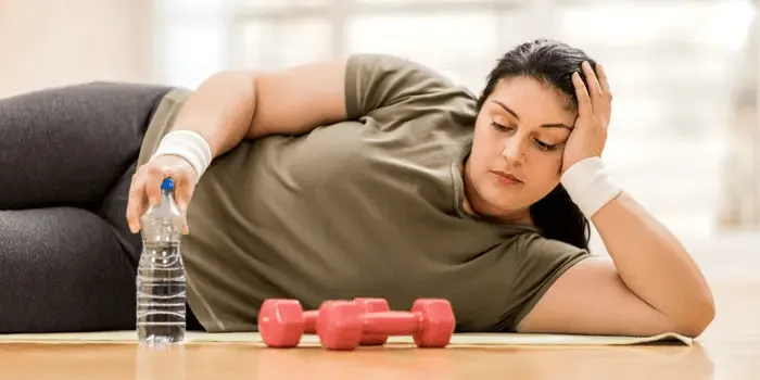 Busy professional looking frustrated with stalled fitness progress