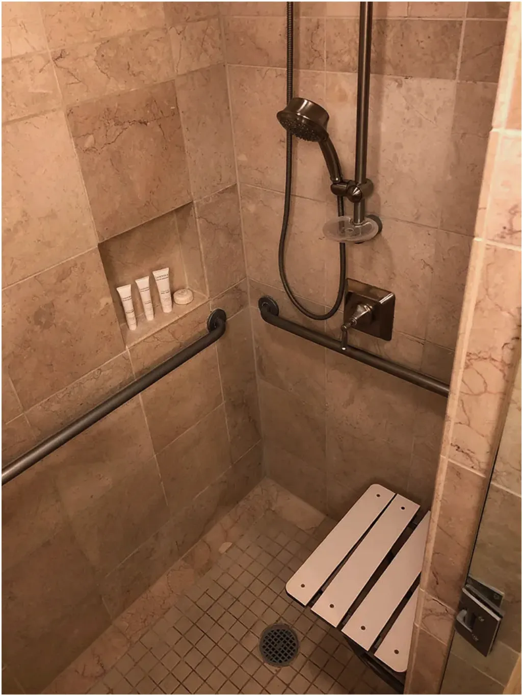 another view of bench and bars and showerhead with controls