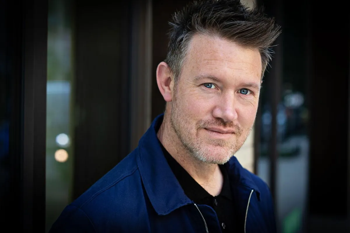 a black and white photo of a woman with her hands on her head