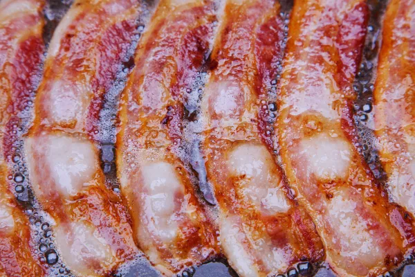 bacon sizzling in a pan