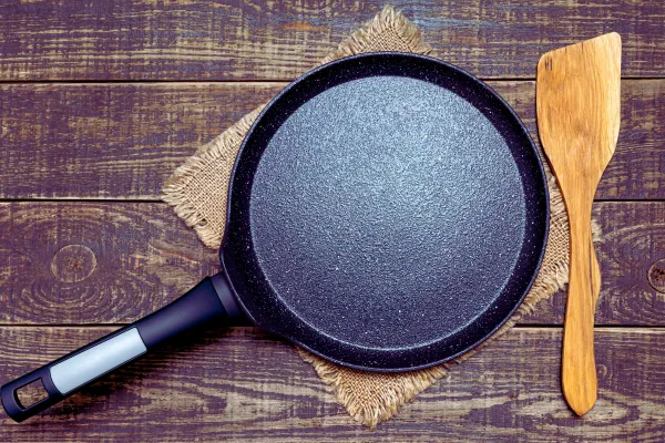 cast iron pan and wooden spatula