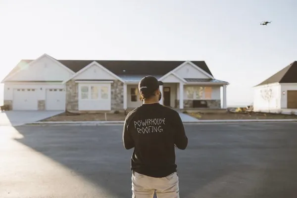 PowerHouse Roofing representative evaluating a residential property during project planning in Utah
