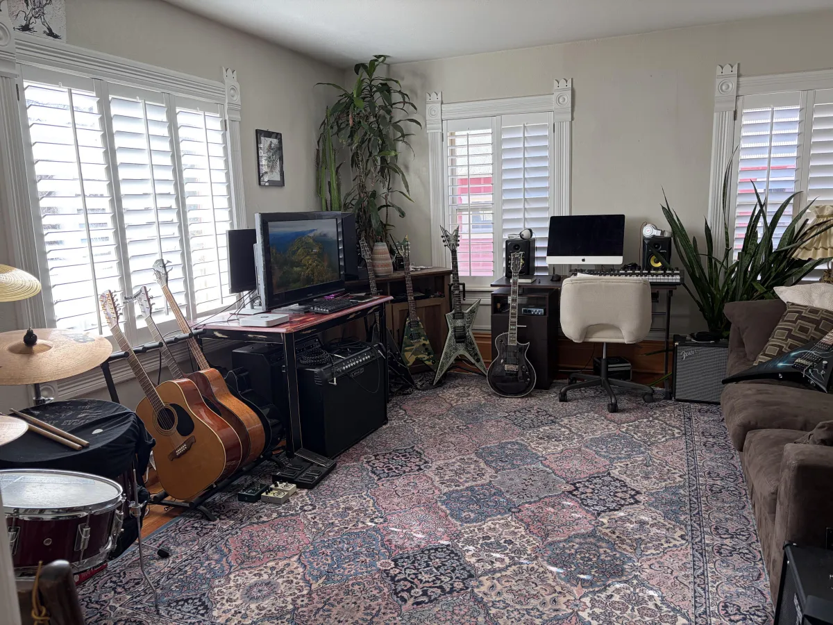 Nate playing electric guitar in his home studio