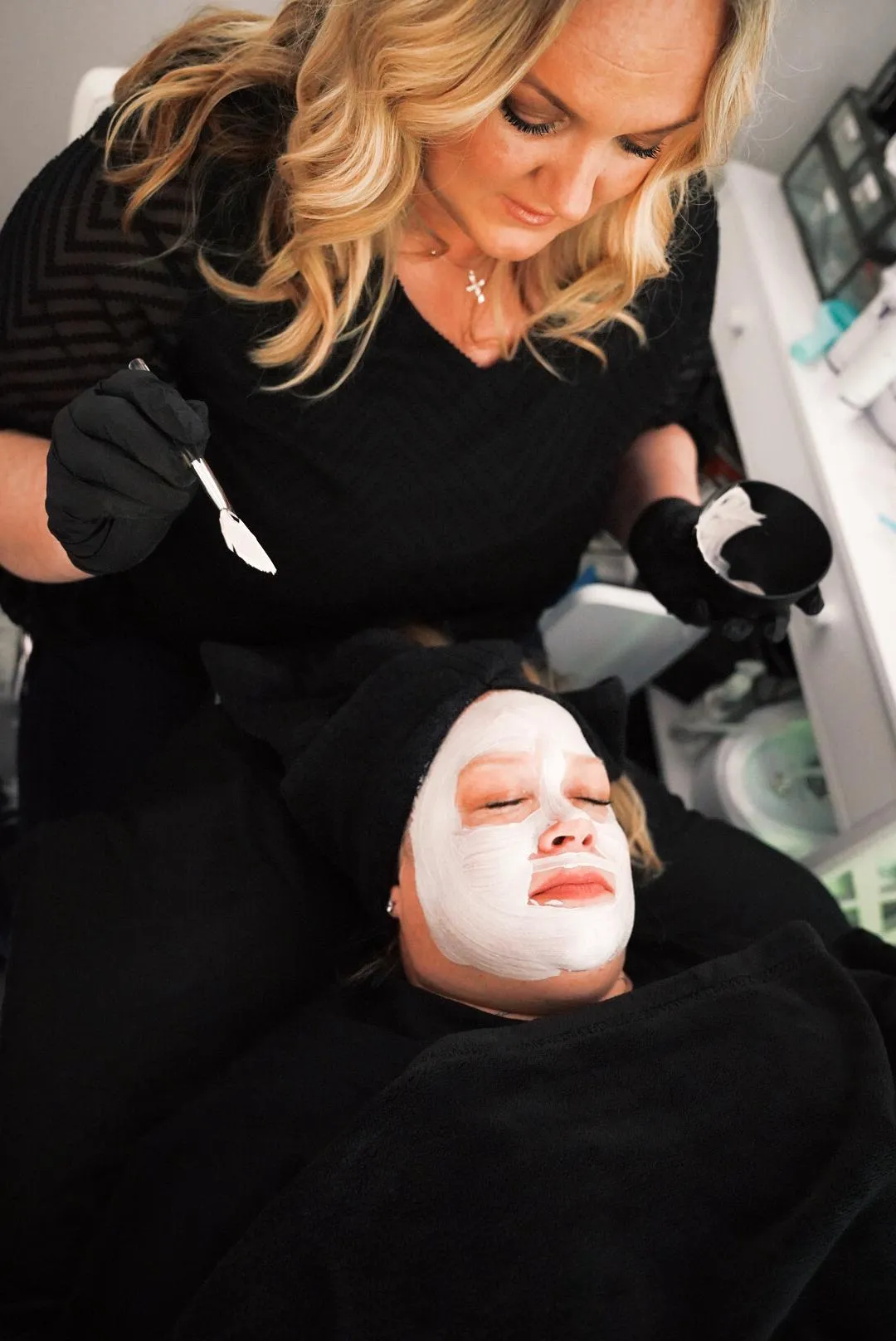 Client receiving an anti-aging, brightening enzyme mask facial in the Good to Glow Facial at Lindsay Rose Beauty in Mansfield, Texas