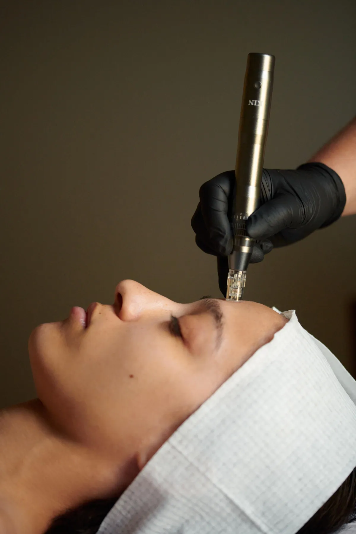 Client receiving a nano-needling treatment to penetrate products deeper by Lindsay Rose Ali at Lindsay Rose Beauty in Mansfield, Texas