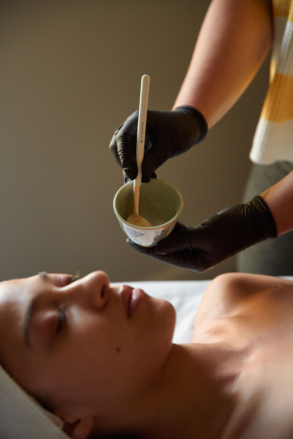 Client receiving an anti-aging, brightening enzyme mask facial in the Good to Glow Facial at Lindsay Rose Beauty in Mansfield, Texas
