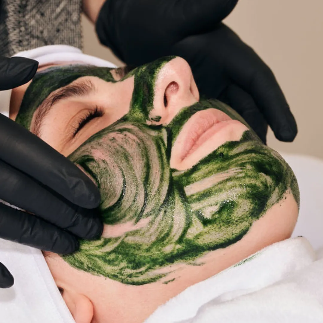 Client receiving the advance gold skin tightening treatment with the gold mask by Lindsay Rose Ali at Lindsay Rose Beauty in Mansfield Texas 