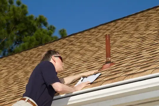 roof inspector looking at roof vent