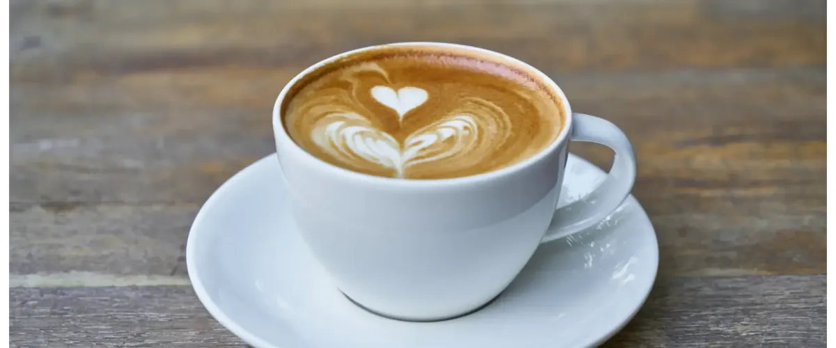 Close-up of an organic artisan latte with heart-shaped foam art at Dubb's Organic Coffee in West Hollywood