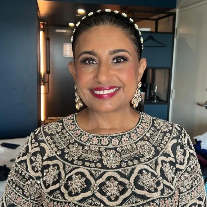 Online styling client Nimrit smiling in a patterned dress and accessories