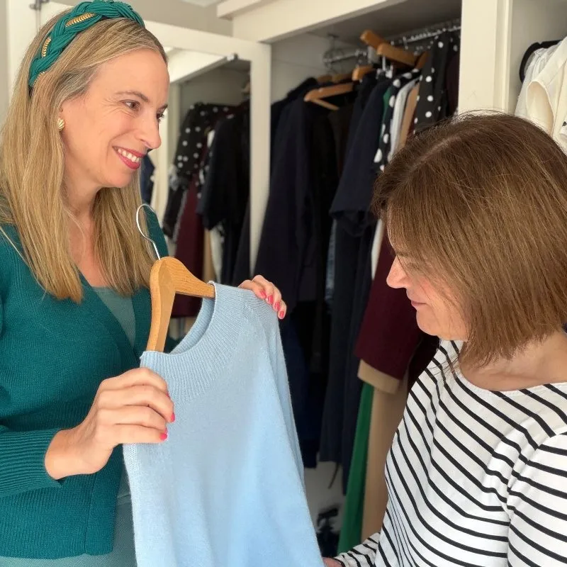 amanda waterstone doing a wardrobe edit with a client discussing a blue top