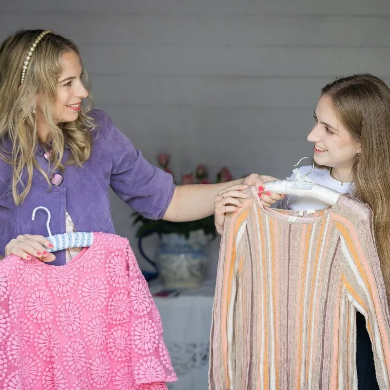 personal stylist buckinghamshire style consultation amanda waterstone with a client holding up a dress and a pink blouse