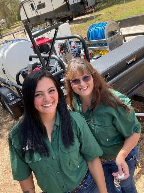 Mom and daughter with pressure washing trailer