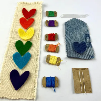 Picture of the supplies in the bookmark taster kit, including felt hearts, threads and needles