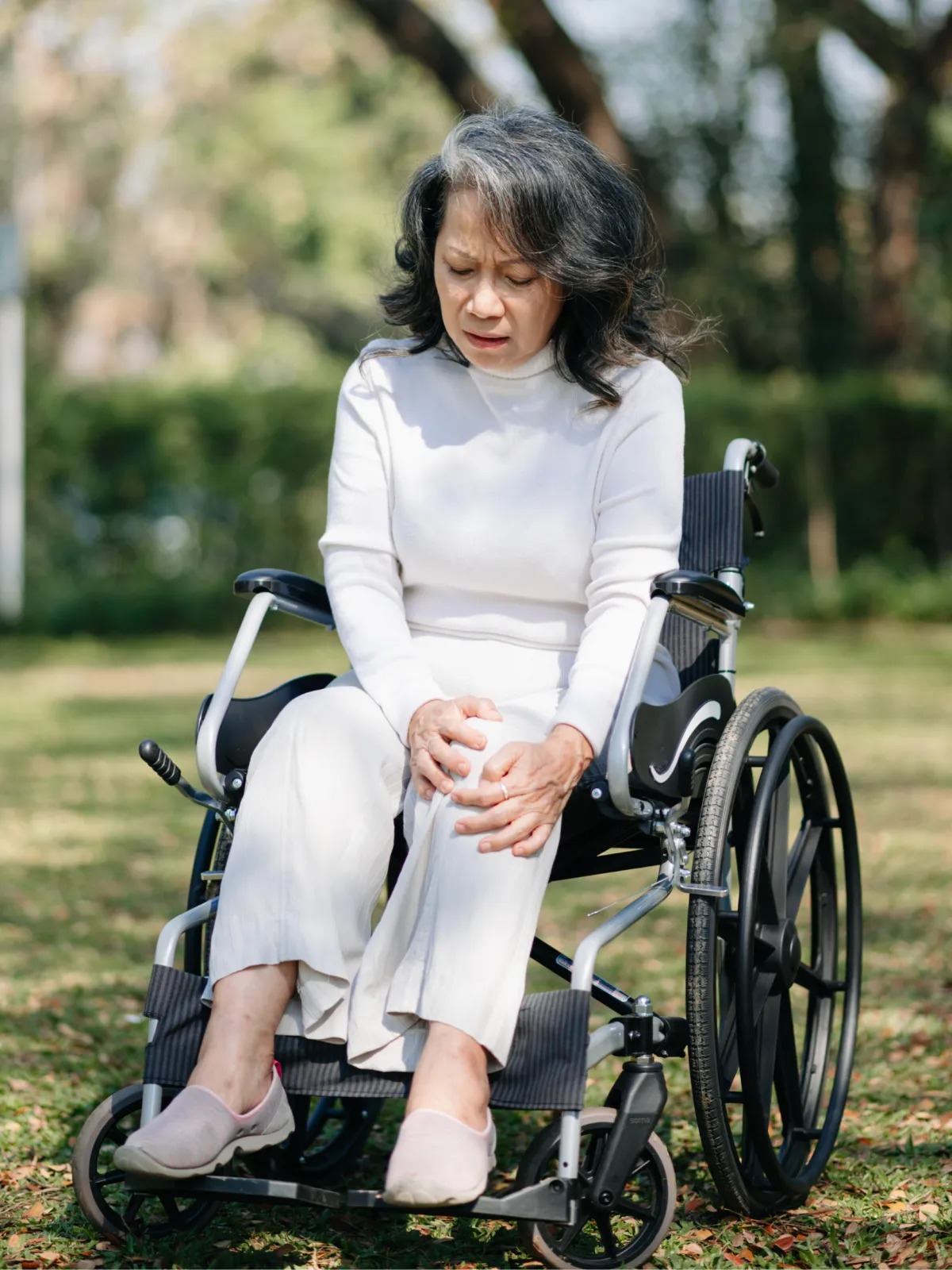 Older woman in wheelchair outdoors, disability, Canadian park