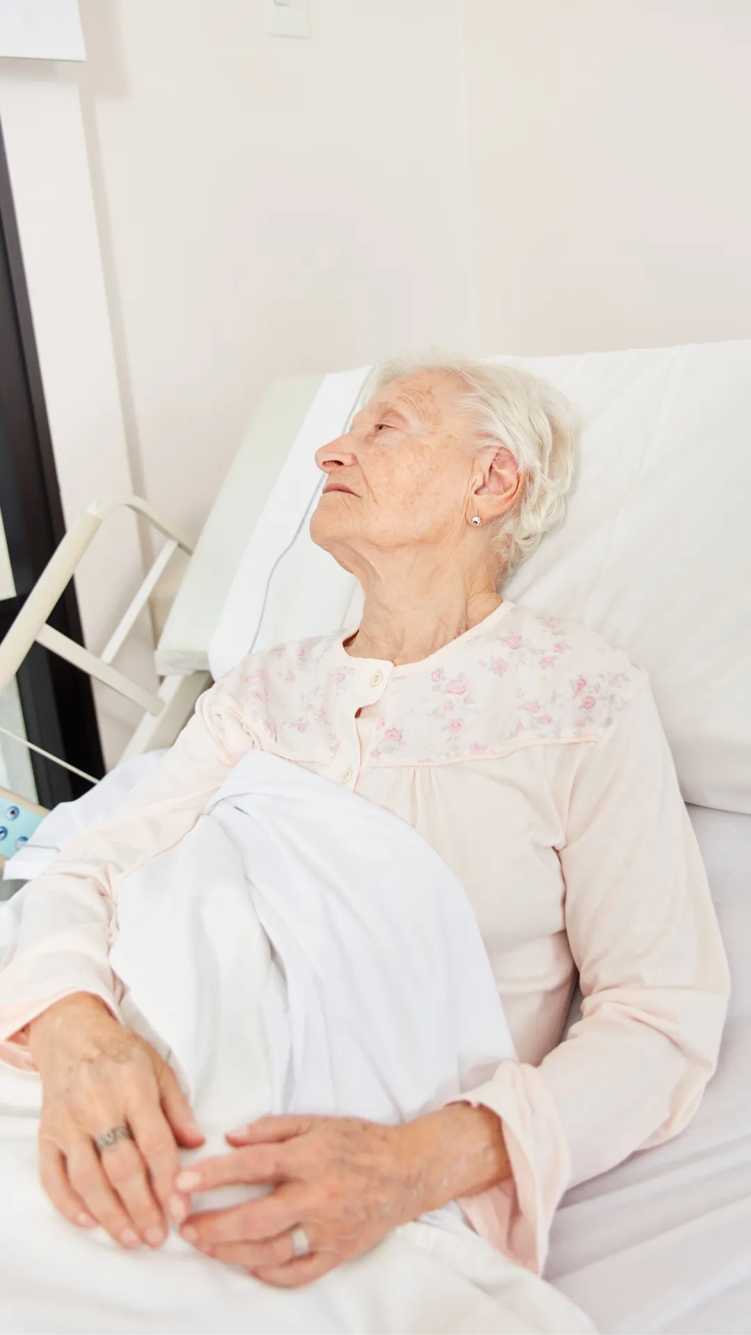 Elderly woman resting in a hospital bed, serene, patient care